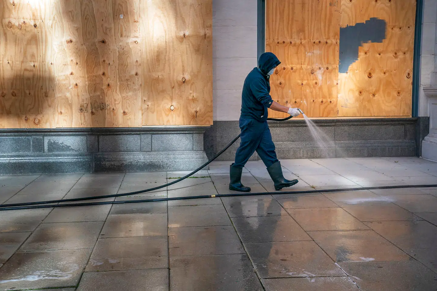 Mens USA og hele verden venter på valgresultatet, spules fortovet foran en af de mange butikker i Washington D.C., der er barrikaderet for at undgå knuste ruder, hvis der opstår uro i gaderne.