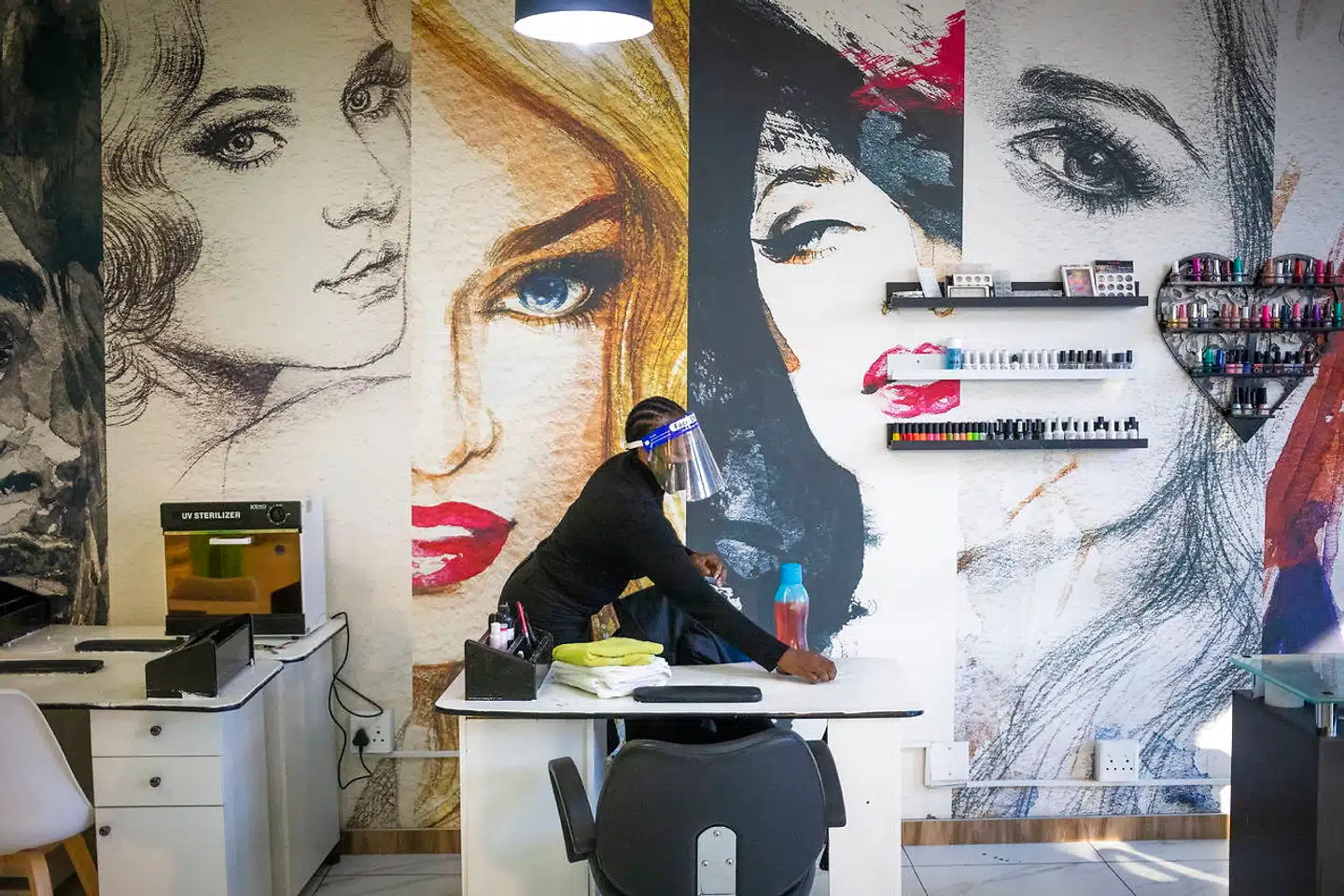 En medarbejder desinficerer skønhedssalonen i Johannesburg i Sydafrika. På trods af apokalyptiske forudsigelser er Afrika indtil videre og i det store og hele sluppet nådigere igennem coronapandemien i forhold til andre kontinenter.