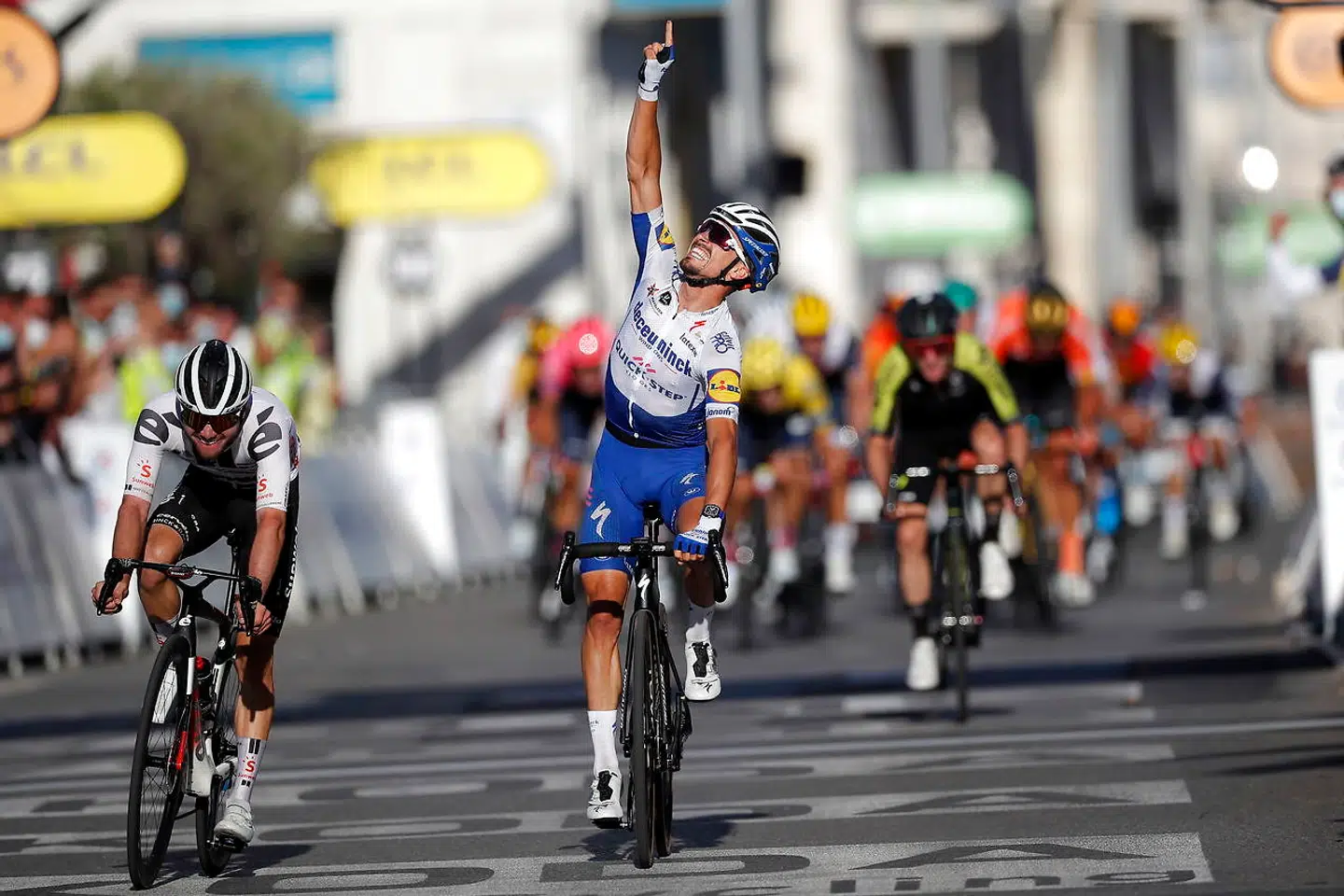 epa08635819 French rider Julian Alaphilippe (C) of the Deceuninck Quick-Step team celebrates as he crosses the finish line to win the 2nd stage of the 107th edition of the Tour de France cycling race over 186km around Nice, France, 30 August 2020. At left second placed Swiss rider Marc Hirschi of Team Sunweb. EPA/Stephane Mahe / Pool