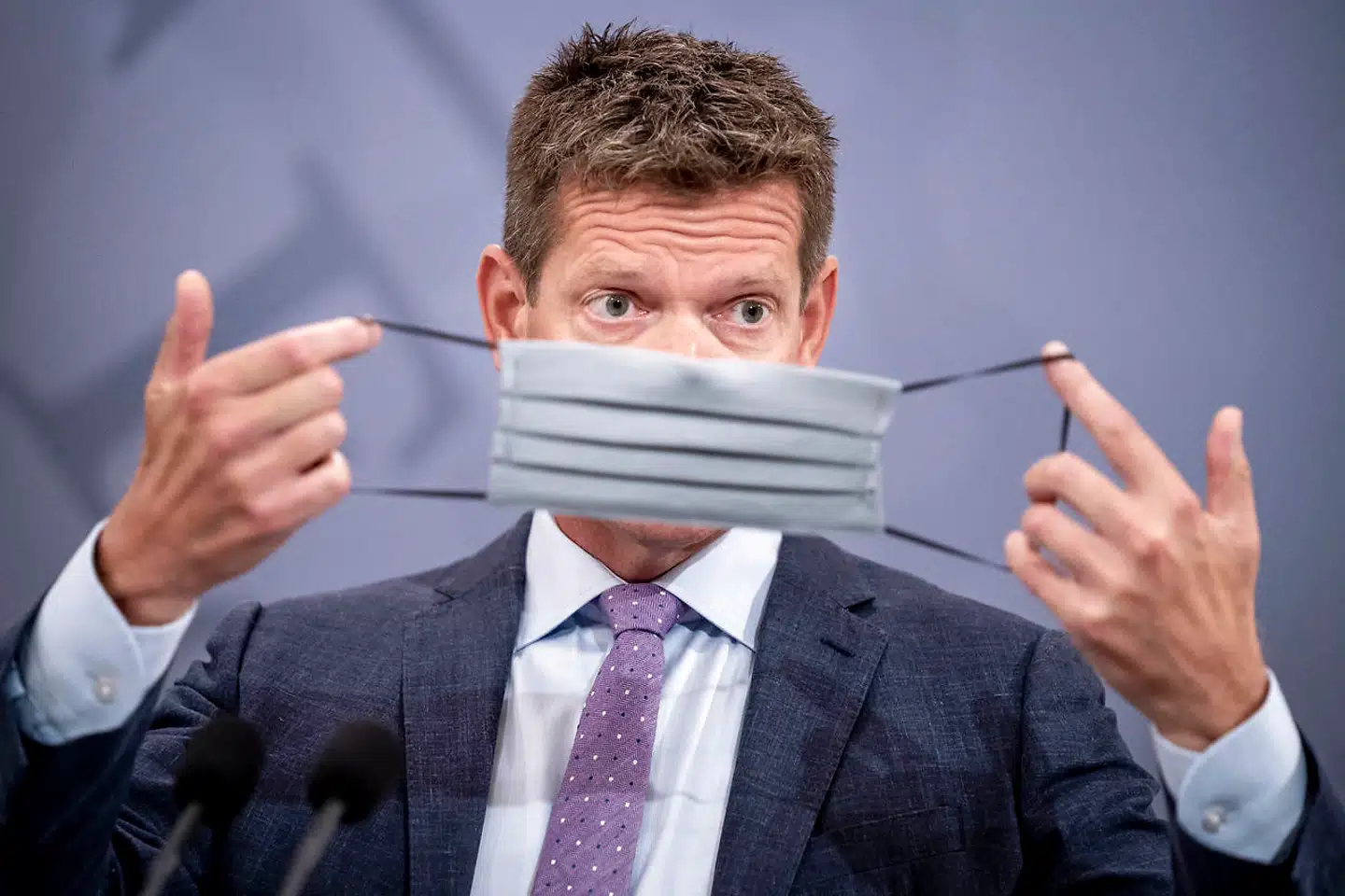 Sundhedsstyrelsens direktør, Søren Brostrøm, demonstrerer, hvordan man tager mundbind på. Et hold forskere fra Aarhus Universitet har undersøgt, om den del af befolkningen, der bruger mundbind, slækker på de øvrige sundhedsanbefalinger.