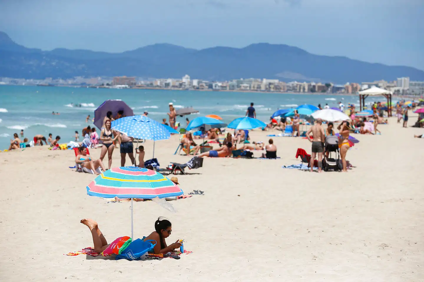 People sunbathe at Playa De Palma beach, as Spain prepares to officially reopen its borders, in Palma de Mallorca, Spain June 14, 2020. REUTERS/Enrique Calvo