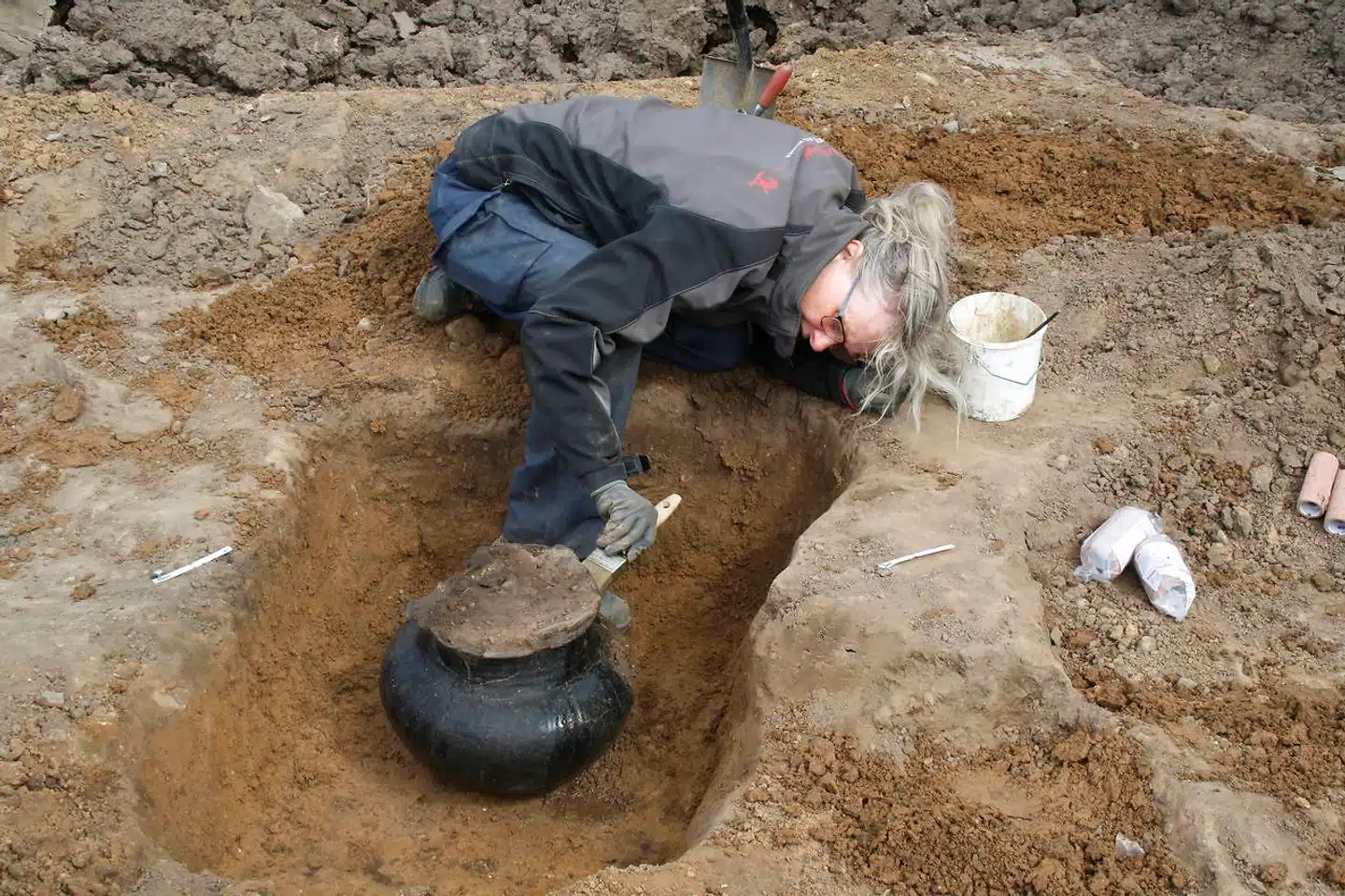 Udgravning af urner fra jernaldergravpladsen omkring den gamle gravhøj.