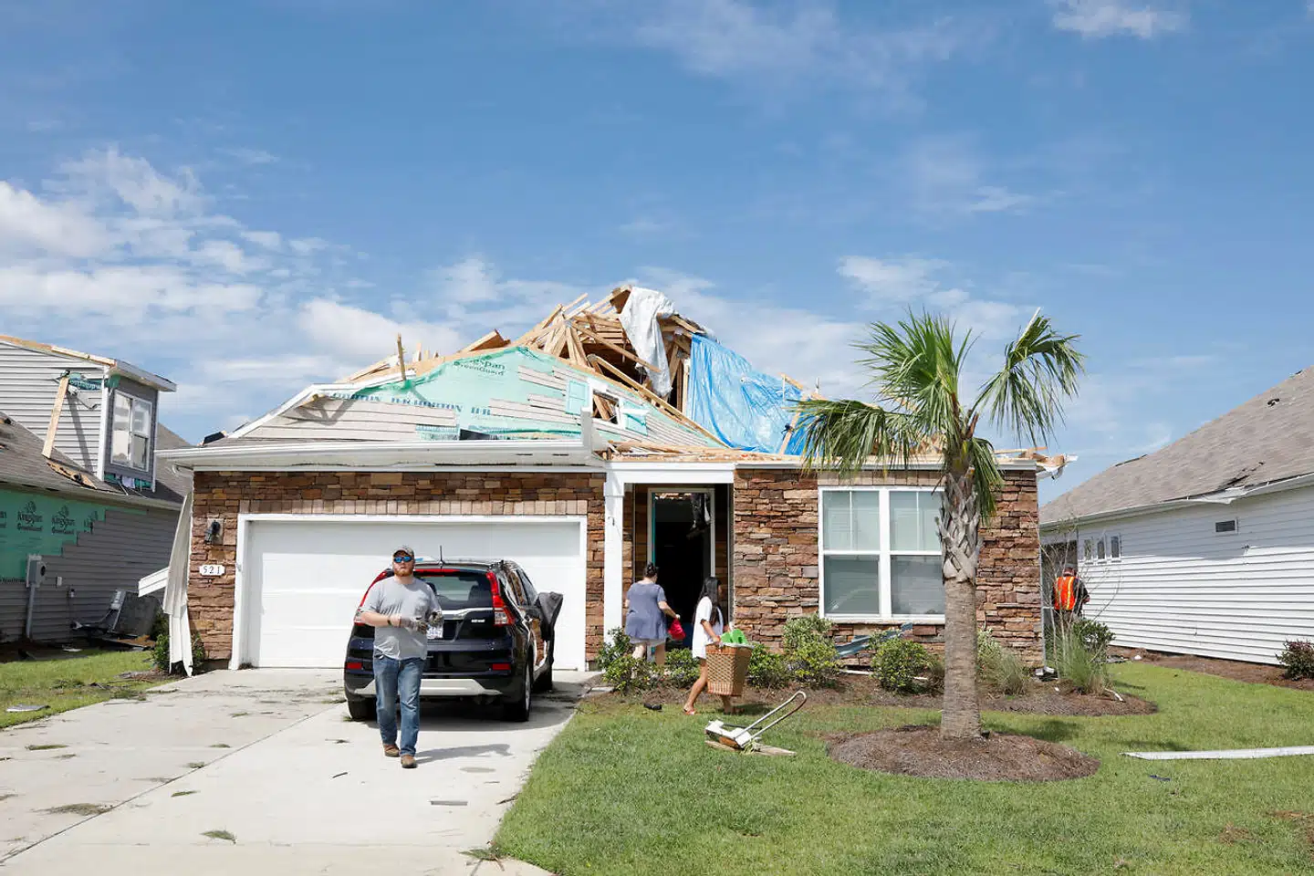 Residents salvage belongings from their damaged home after a tornado spawned by Hurricane Dorian ripped open its roof, in Carolina Shores, North Carolina, U.S., September 6, 2019. REUTERS/Jonathan Drake