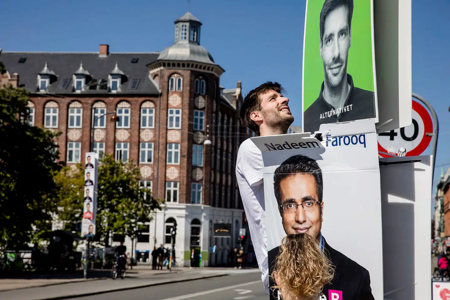 Jonathan Ries forsøger at få plads til sine valgplakater blandt de mange fra Europa-parlamentsvalget.