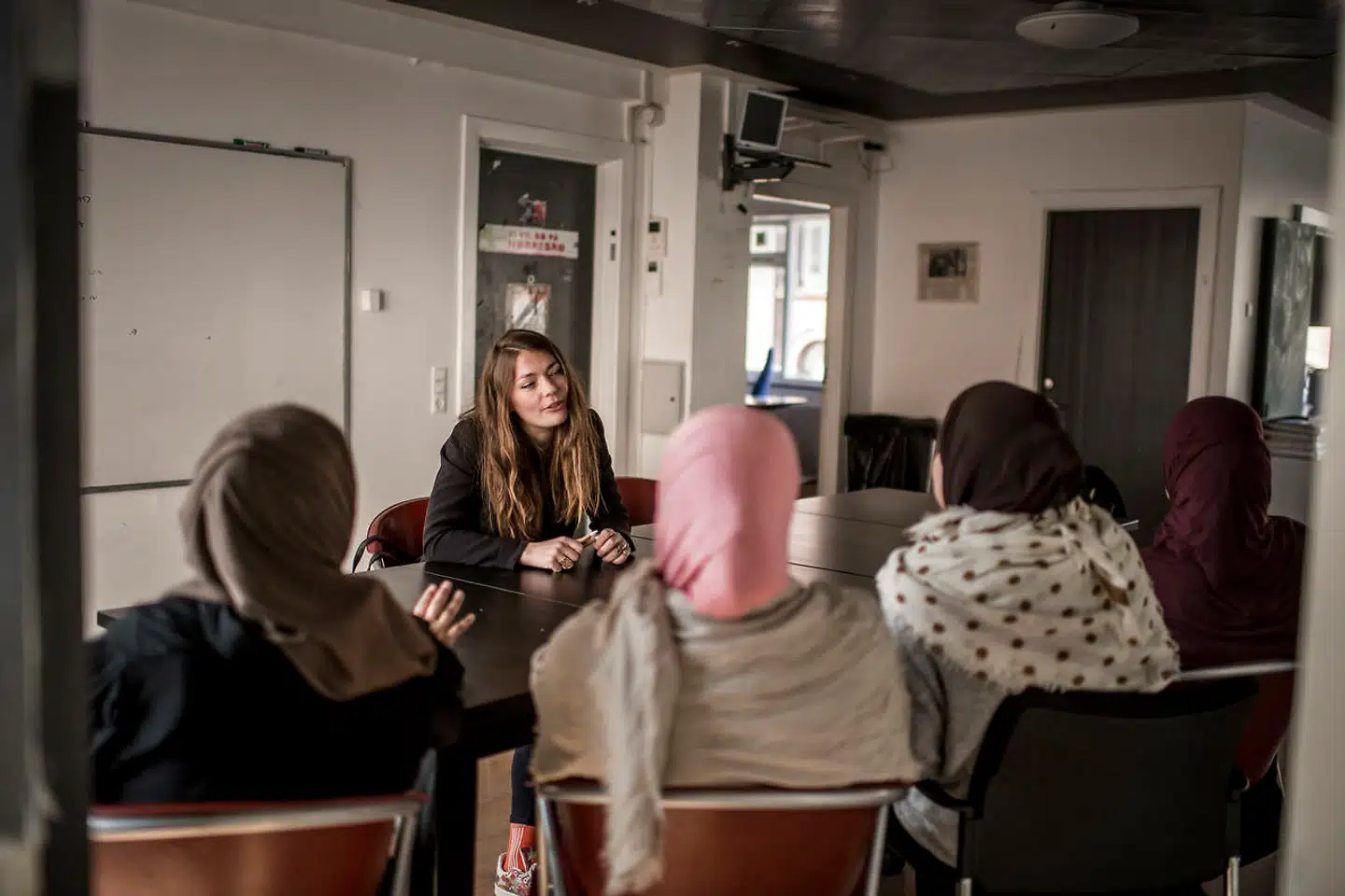 Socialarbejder Mathilde Støvring taler med fire af mødrene i det kommunale projekt De Aktive Drenge.