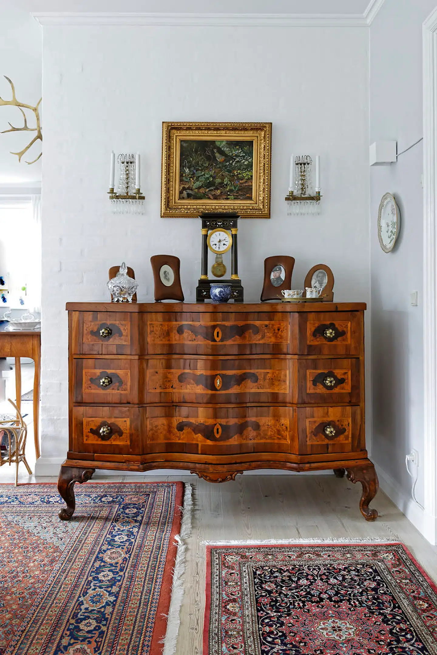 Den sønderjyske dragkiste fra 1780 blev købt af Vivian Birchs forældre. Da deres hjem på Vesterbrogade brændte, fik dragkisten skader, som for nylig er restaureret. I antikke rammer står billeder af parrets aner.