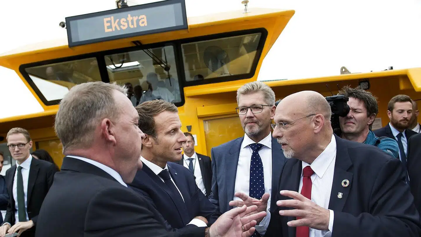 Realdanias topchef, Jesper Nygård (til højre med rødt slips), i samtale med den franske præsident, Emmanuel Macron (nr. to fra venstre), mens statsminister Lars Løkke Rasmussen og Københavns overborgmester, Frank Jensen, lytter under Macrons officielle statsbesøg i august 2018.