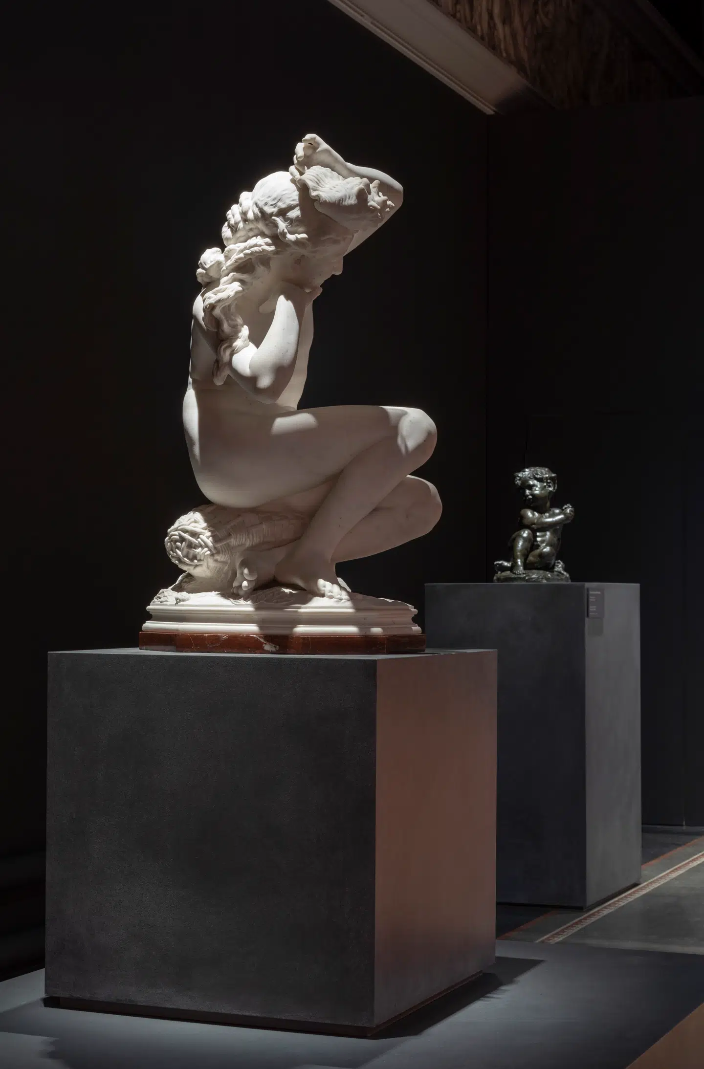 Der kan være flere grunde til at indtage en positur, der traditionelt anses for yndefuld. Denne kvinde gør det, fordi hun lytter til en konkylie. Marmorskulpturen er udført af den franske billedhugger Jean-Baptiste Carpeaux omkring 1864.