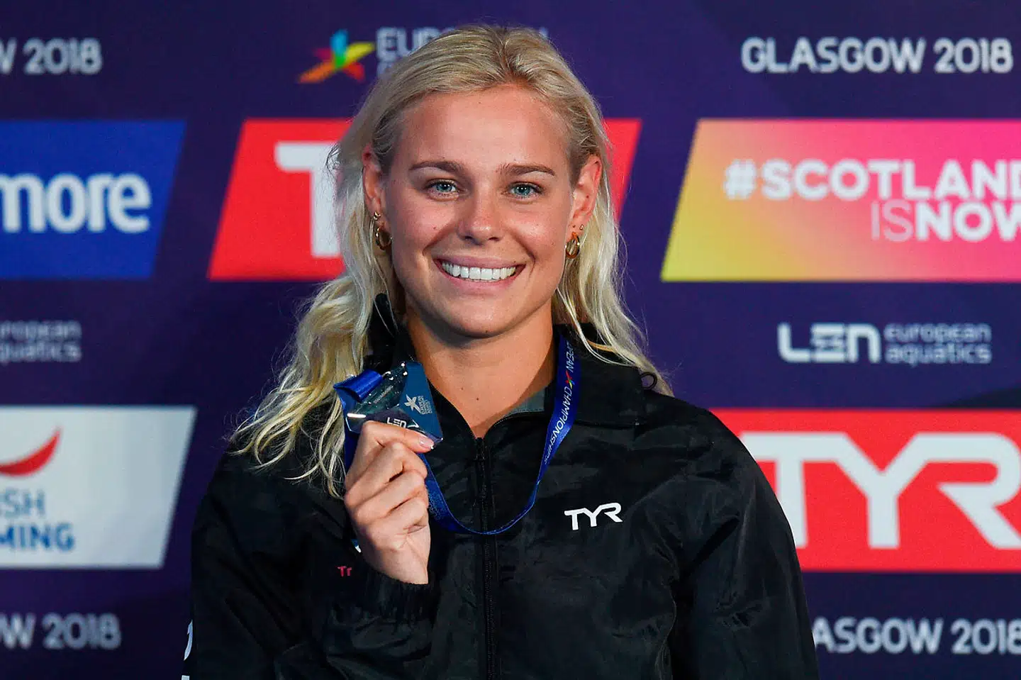 Silver medallist Denmark's Pernille Blume poses on the podium during the medal ceremony for the Women's 50m freestyle swimming final at the Tollcross swimming centre during the 2018 European Championships in Glasgow on August 4, 2018. Oli SCARFF / AFP
