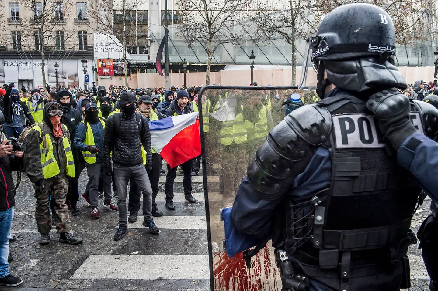 Protestbevægelsen Gule Veste demonstrerer omkring Triumfbuen i Paris. Den franske nationalsang lyder, mens tåregasgranater bliver skudt afsted fra et presset fransk politi.