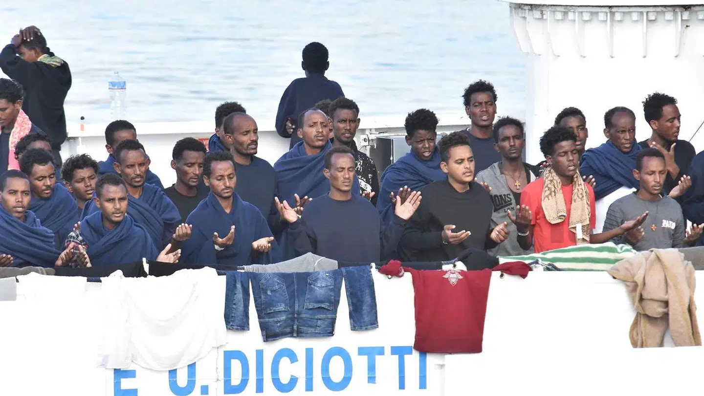 22. august 2018: Migranter beder en bøn, da et skib fra den italienske kystvagt bringer dem i havn i Catania på Sicilien. De bedende var forinden blevet reddet fra druknedøden i havet ud for Lampedusa.