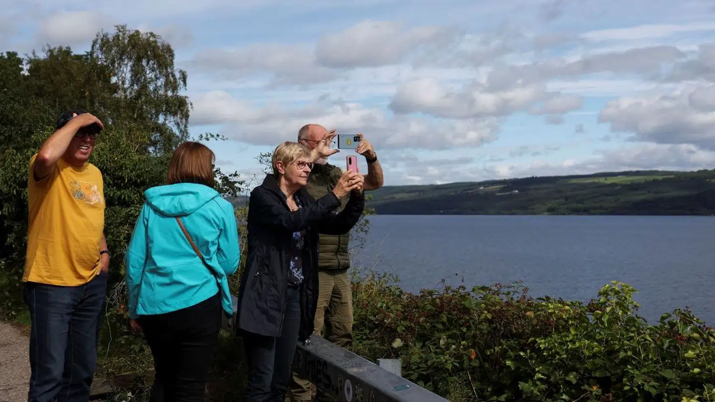 German tourists take pictures of Loch Ness as people take part in the largest Loch Ness Monster hunt for 50 years in Scotland, Britain, August 27, 2023. REUTERS/Russell Cheyne