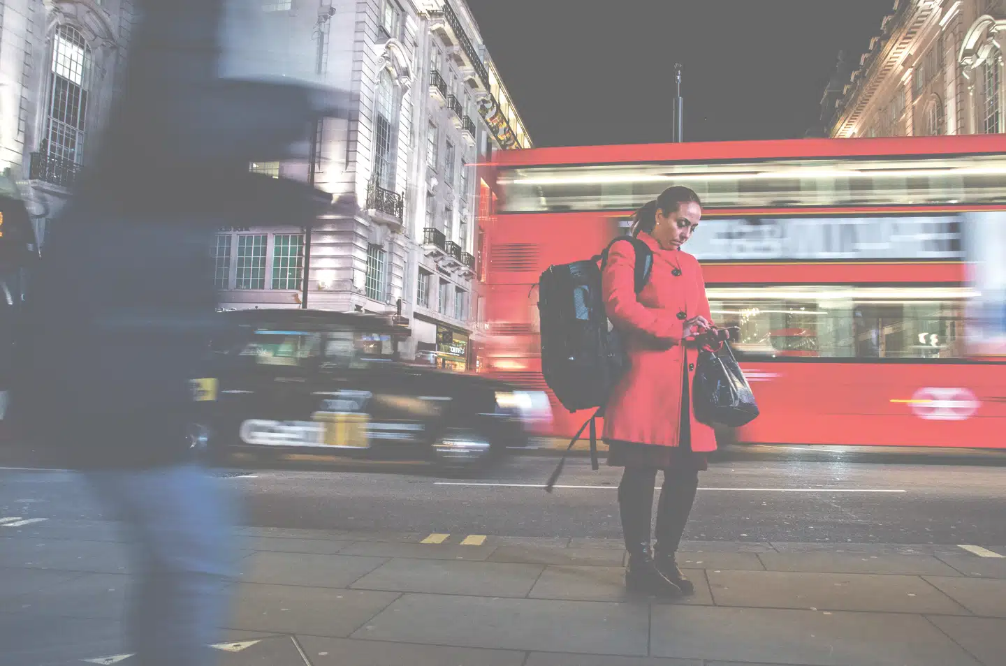 Med lang lukkertid kommer biler og mennesker i bevægelse til at se uskarpe og rystede ud, mens kvinden i den røde frakke rammes af lyset fra kameraets flash. Derfor står hun skarpt.