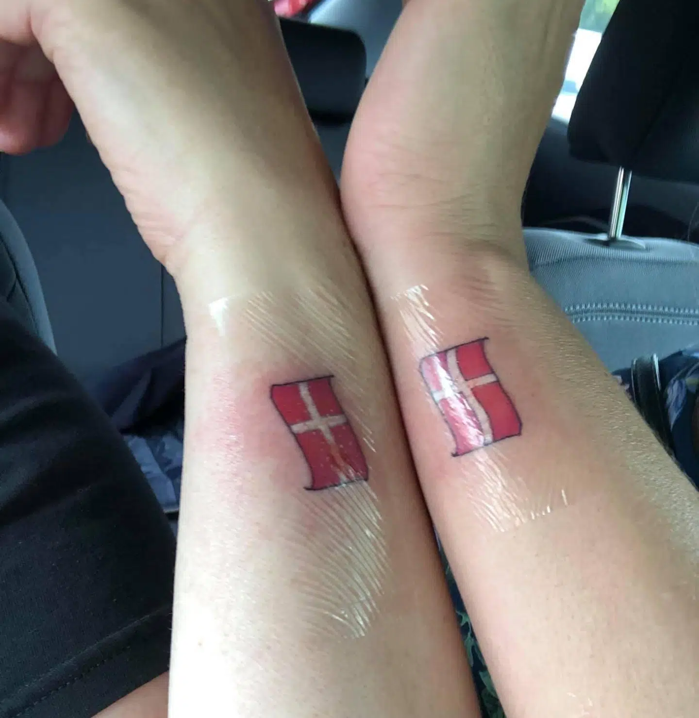 Små dannebrogs-tatoveringer.