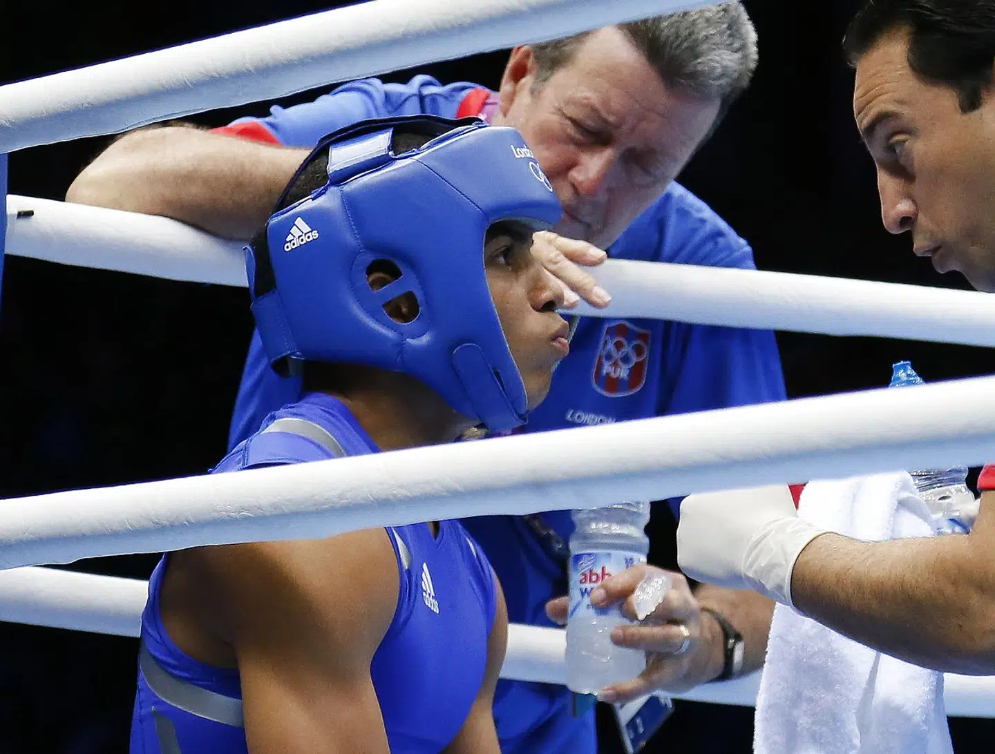 Felix Verdejo Sanchez of Puerto Rico listens to his corner between rounds against Ahmed Mejri of Tunisia during their Lightweight (60kg) match of the London 2012 Olympic Games at the ExCel Arena on August 2, 2012 in London. Verdejo Sanchez was awarded a 16-7 points decision. AFP PHOTO / Jack GUEZ. JACK GUEZ / AFP