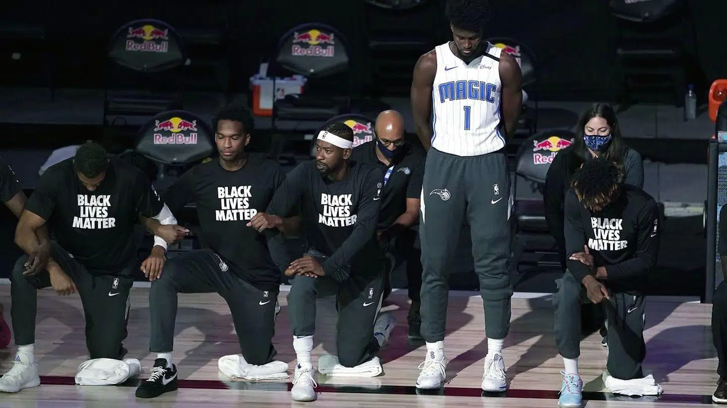 Orlando, FL - JULY 31: Jonathan Isaac #1 of the Orlando Magic stands as others kneel before the start of a game between the Brooklyn Nets and the Orlando Magic on July 31, 2020 at The HP Field House at ESPN Wide World Of Sports Complex in Orlando, Florida. NOTE TO USER: User expressly acknowledges and agrees that, by downloading and/or using this Photograph, user is consenting to the terms and conditions of the Getty Images License Agreement. Ashley Landis - Pool/Getty Images/AFP == FOR NEWSPAPERS, INTERNET, TELCOS & TELEVISION USE ONLY ==