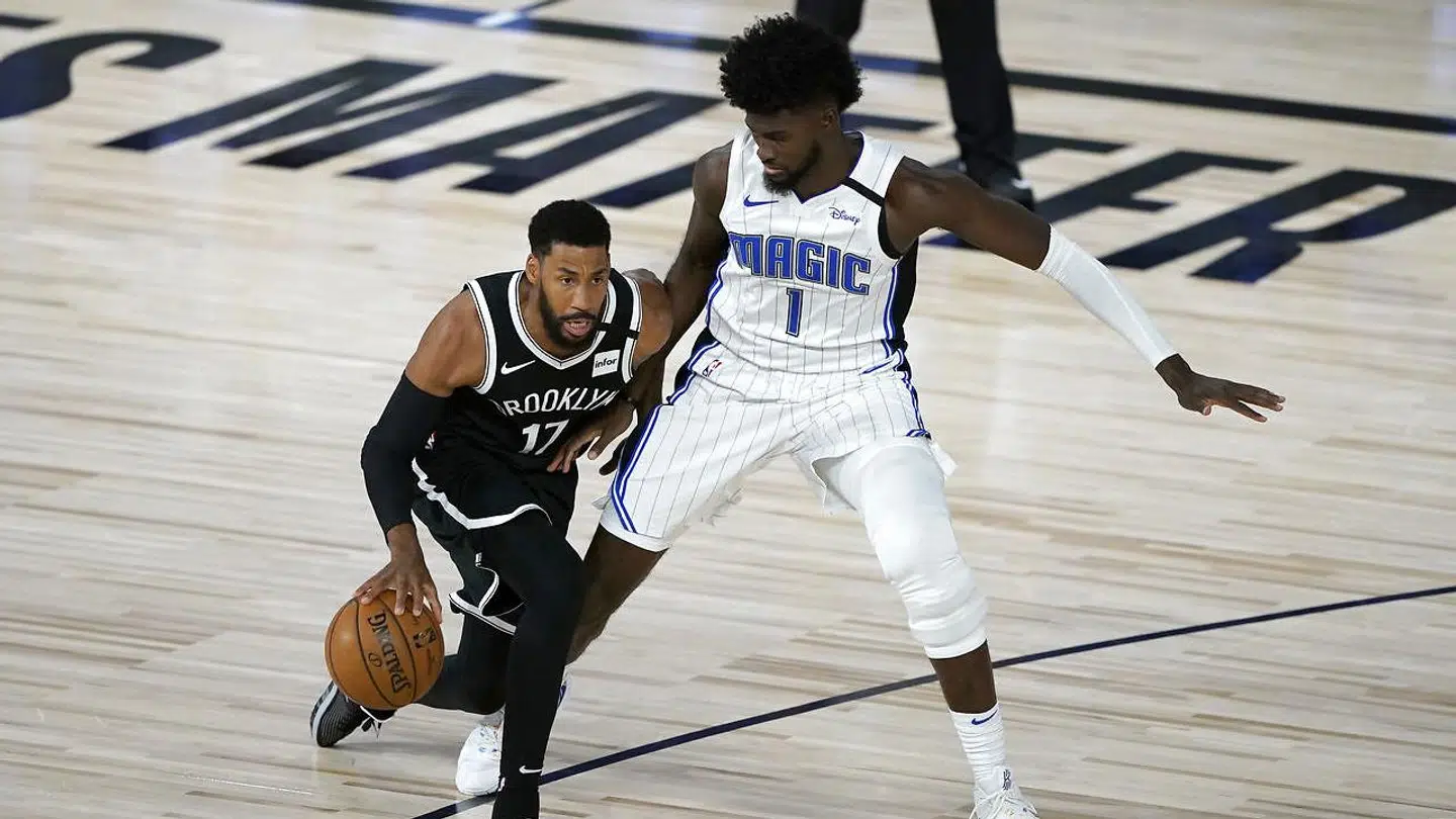 July 31, 2020; Lake Buena Vista, USA; Brooklyn Nets' Garrett Temple (17) dribbles as Orlando Magic's Jonathan Isaac (1) defends during the first half of an NBA basketball game. Mandatory Credit: Ashley Landis/Pool Photo via USA TODAY Sports