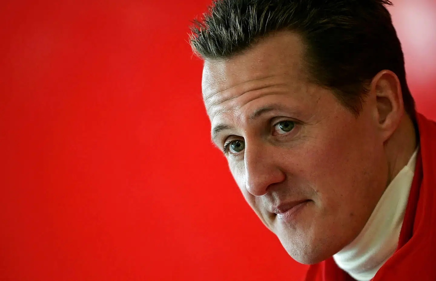 Ferrari Formula One driver Michael Schumacher of Germany looks on during a news conference at the Mugello racetrack in Scarperia, central Italy in this January 24, 2006 file photo. Formula One ex-champion Schumacher, who sustained severe head injuries in a ski accident in late 2013, is no longer in a coma and has left the French hospital where he was being treated since the accident, his spokeswoman said on June 16, 2014. REUTERS/Tony Gentile/Files (ITALY - Tags: SPORT MOTORSPORT F1)