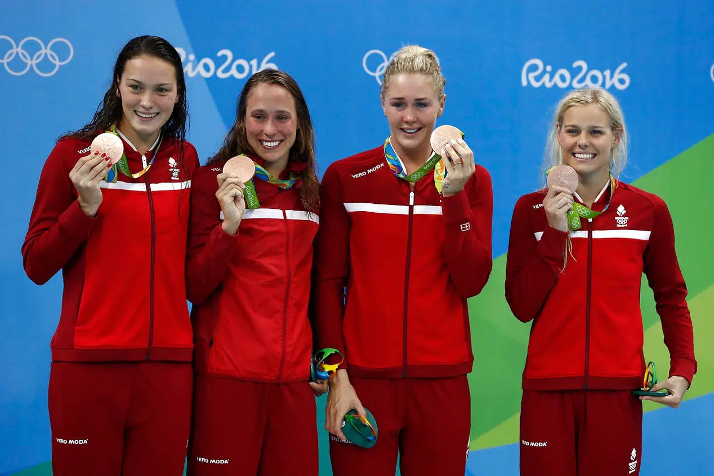 Denmark's bronze medallist team Mie Nielsen, Rikke Moller Pedersen, Jeanette Ottesen, Pernille Blume pose during the podium ceremony of the Women's swimming 4 x 100m Medley Relay Final at the Rio 2016 Olympic Games at the Olympic Aquatics Stadium in Rio de Janeiro on August 13, 2016. . Odd ANDERSEN / AFP