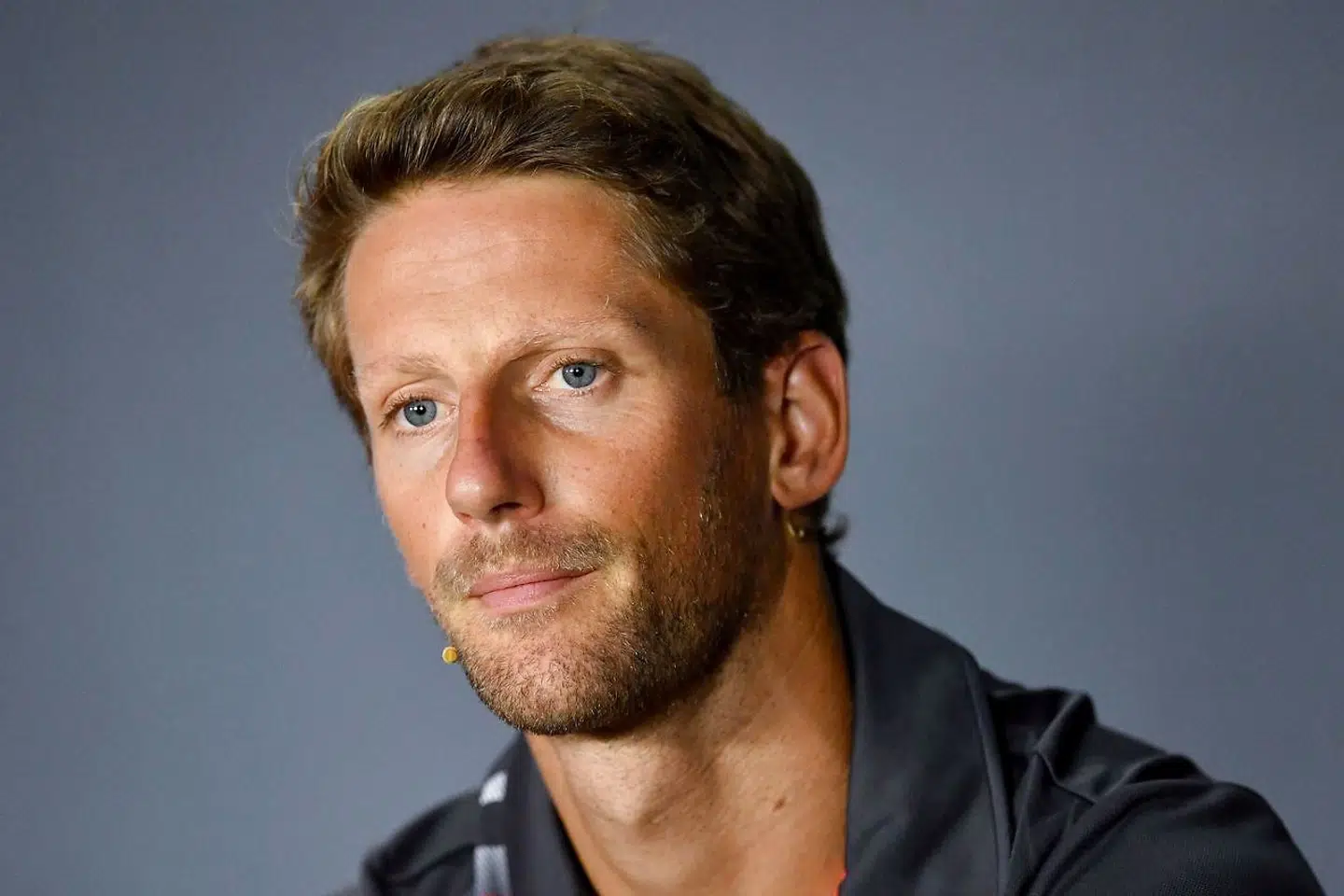 (FILES) In this file photo taken on August 30, 2018 Haas F1's French driver Romain Grosjean addresses a press conference at the Autodromo Nazionale circuit in Monza on August 30, 2018 ahead of the Italian Formula One Grand Prix. Romain Grosjean is returning home to Switzerland for treatment on the burns he suffered from his fireball crash in Bahrain and will miss the season-closing Abu Dhabi Grand Prix, his Haas team announced on December 6. (Photo by ANDREJ ISAKOVIC / AFP)