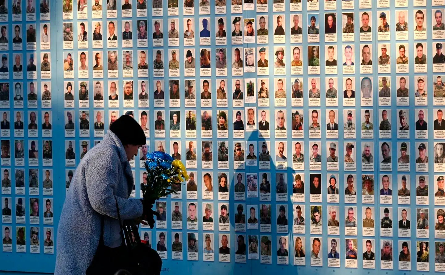 Ukrainske styrker anvender ansigtsgenkendelse til at identificere døde russiske soldater via sociale medier. På billedet er lægger en kvinde blomster ved mindevægggen over Ukraines egne faldne i Kyiv den 17 januar, 2024.